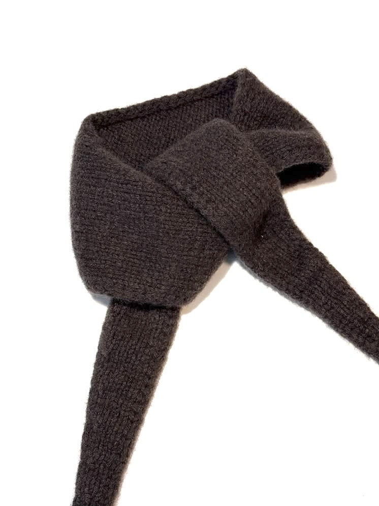 A dark brown knitted scarf tied in a knot, displayed against a plain white background.